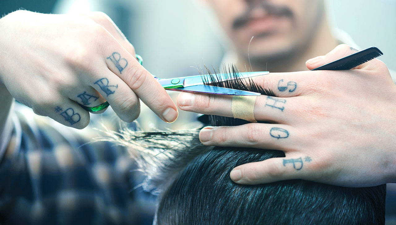 Barber stylt Haare des Kunden.